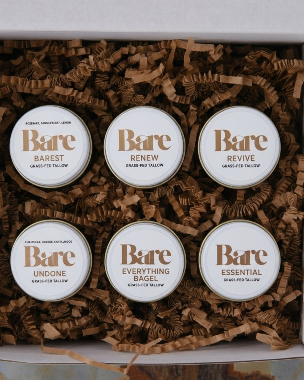 The Collection Discovery Set: six grass-fed tallow balms (Barest, Renew, Revive, Undone, Everything Bagel, Essential) in a kraft gift box